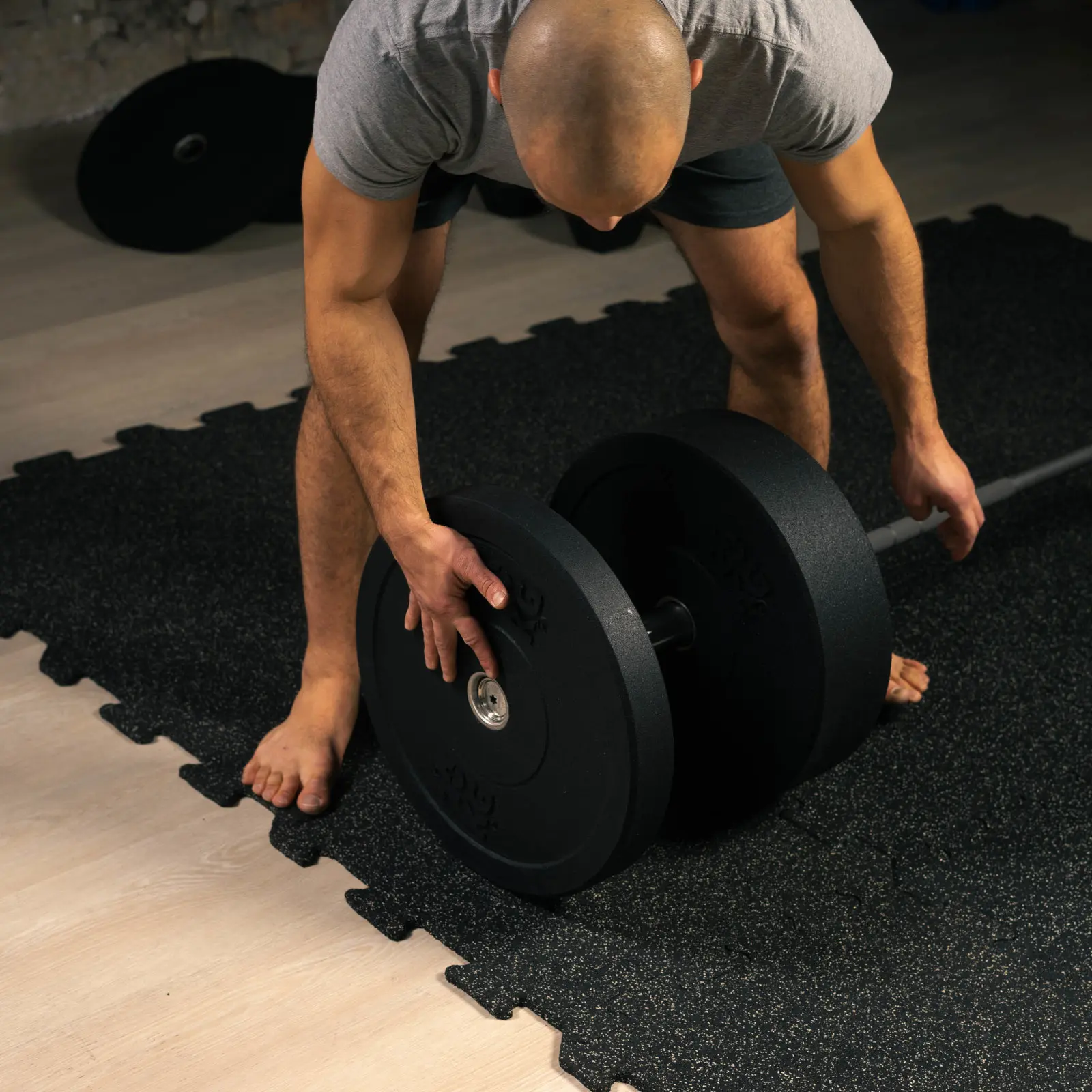 Präsentation des Auflegens der Bumper Plates ST auf die Olympia-Langhantel